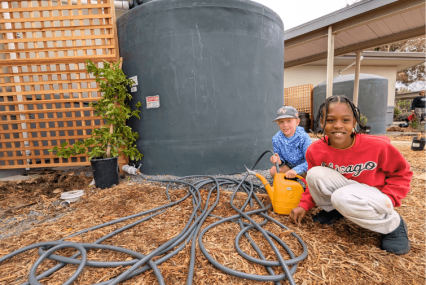 Students at La Tercera Elementary School Filling a Watering Can with Rainwater to Use on the Landscape - Morgan Margulies